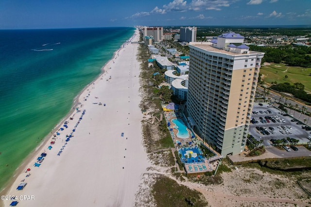 drone / aerial view featuring a water view and a beach view