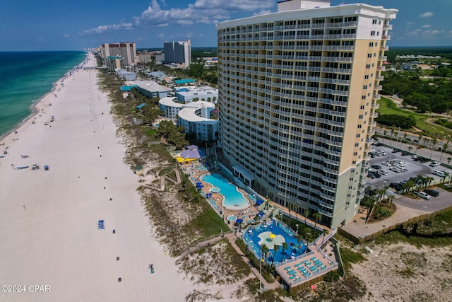 bird's eye view featuring a water view and a beach view