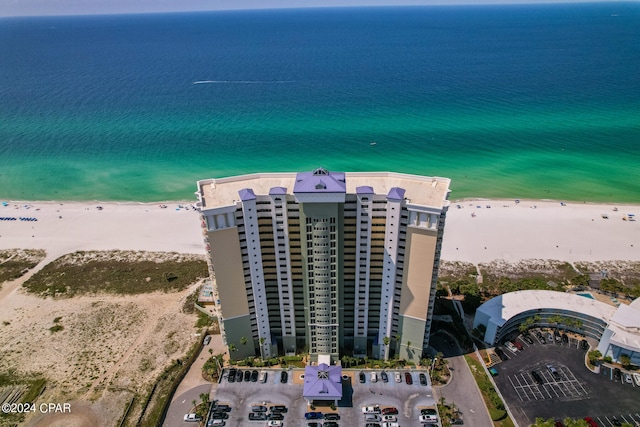 drone / aerial view with a beach view and a water view