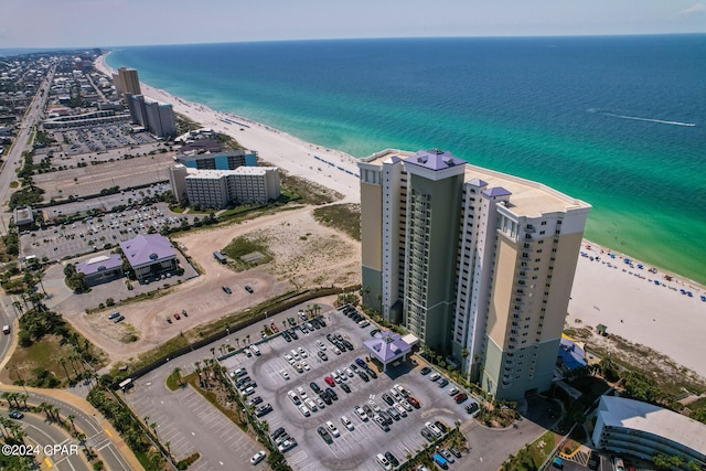 drone / aerial view with a water view and a beach view