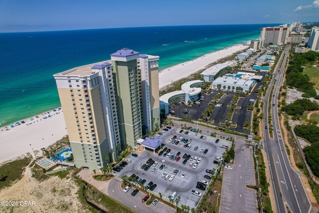 drone / aerial view featuring a water view and a beach view