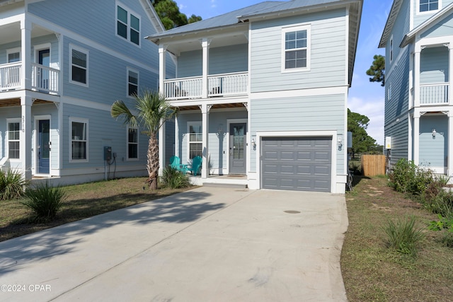 view of front facade with a balcony and a garage