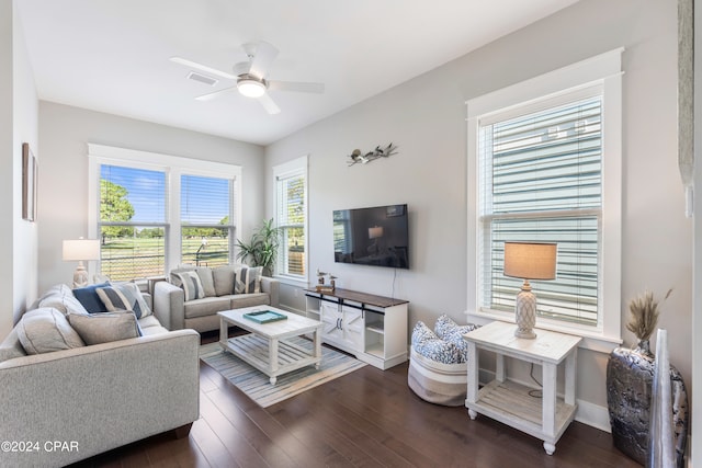 living room featuring dark hardwood / wood-style flooring and ceiling fan