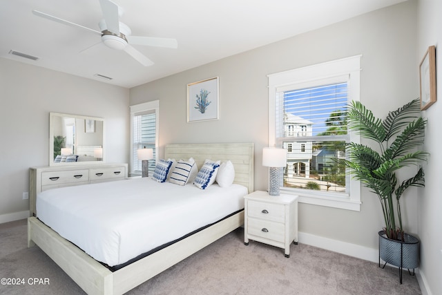 bedroom with ceiling fan and light colored carpet