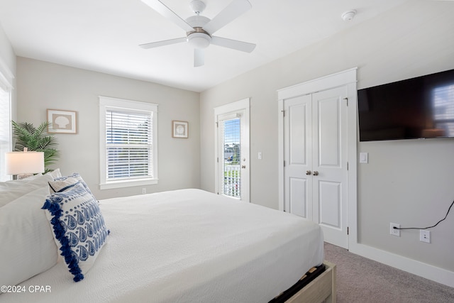 carpeted bedroom with ceiling fan and access to exterior