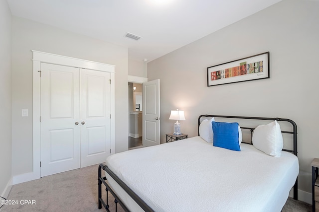 bedroom featuring light carpet and a closet