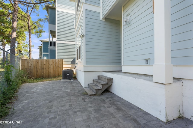 view of property exterior with central AC and a patio area