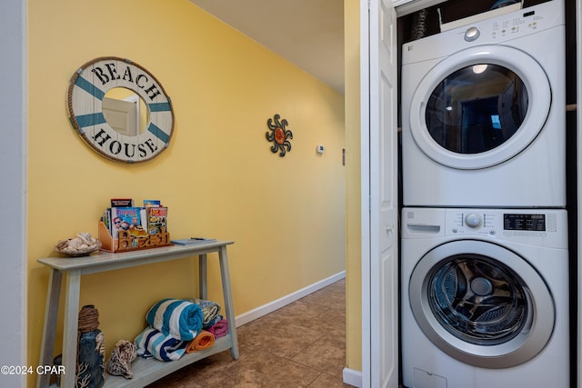 washroom with stacked washer and dryer and light tile patterned floors