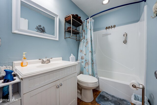 full bathroom with vanity, a textured ceiling, toilet, and shower / bathtub combination with curtain