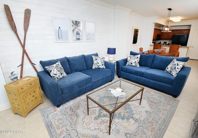 living room with crown molding and light tile patterned floors