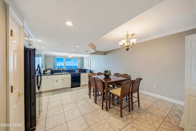 tiled dining room with crown molding, sink, and a chandelier