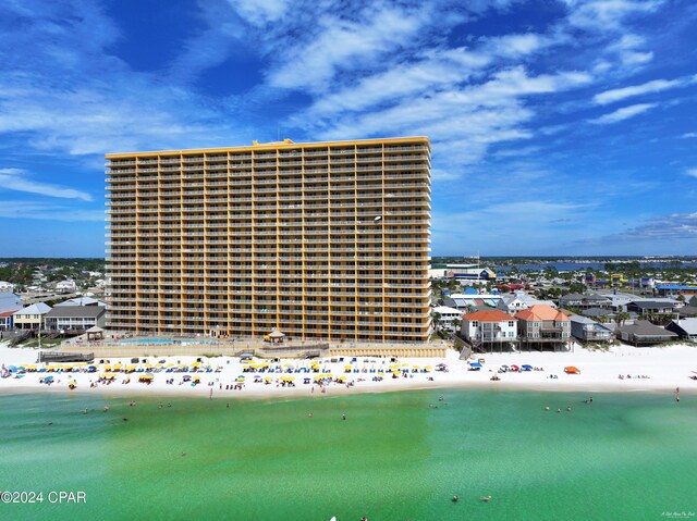 view of property with a beach view and a water view