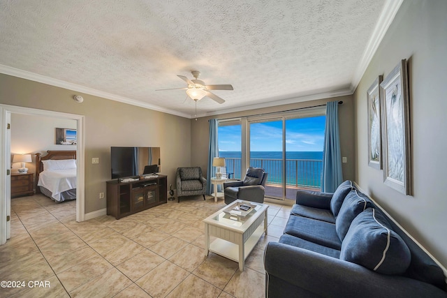 living room featuring a textured ceiling, ornamental molding, ceiling fan, and light tile patterned flooring