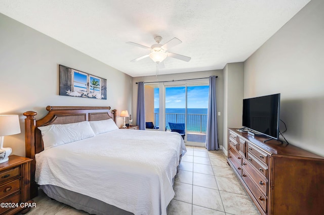 bedroom with ceiling fan, access to exterior, a textured ceiling, and light tile patterned floors