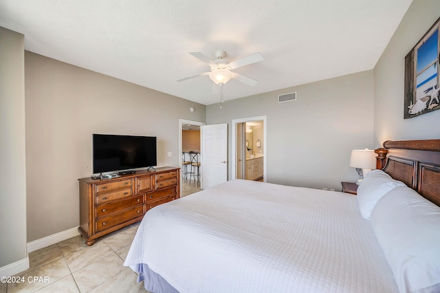 tiled bedroom with ceiling fan and ensuite bathroom