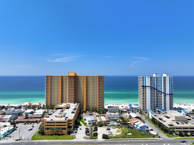 birds eye view of property with a water view and a beach view