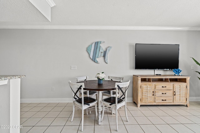 dining area with a textured ceiling, light tile patterned floors, baseboards, and ornamental molding