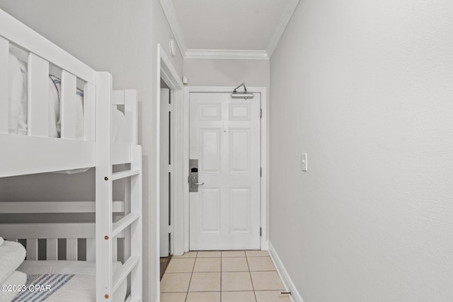 interior space featuring light tile patterned flooring, baseboards, and ornamental molding