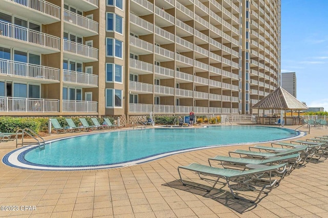 community pool with a gazebo