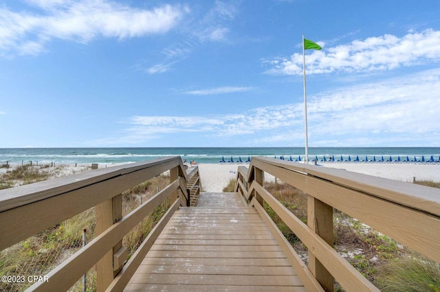 view of property's community with a beach view and a water view