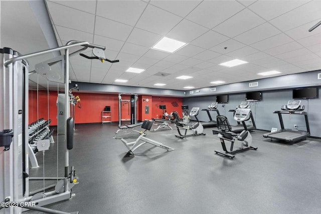 gym featuring a paneled ceiling and visible vents