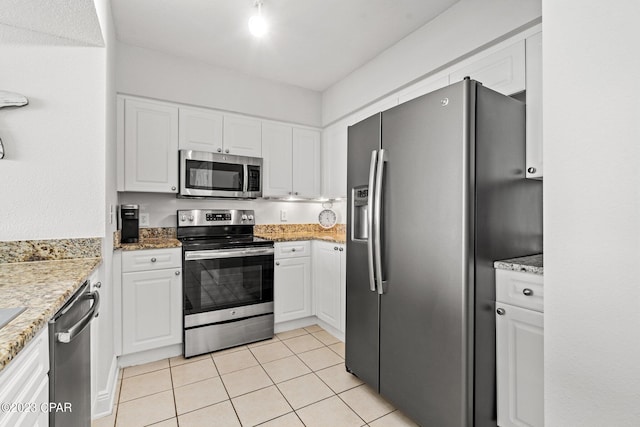 kitchen featuring light tile patterned flooring, white cabinetry, and stainless steel appliances