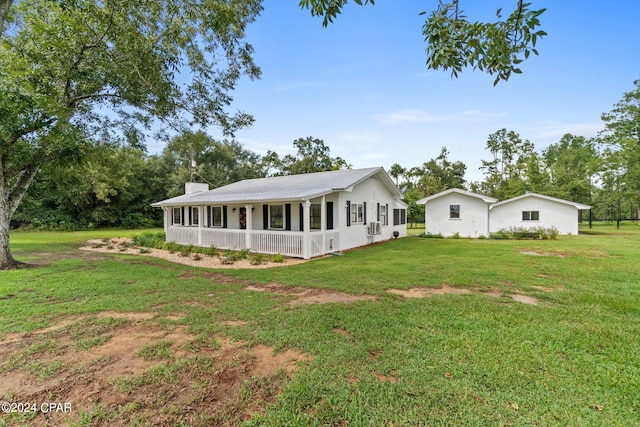 back of house with a lawn