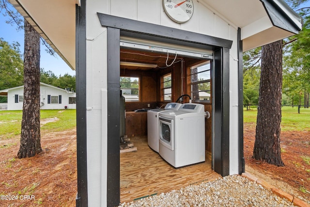 clothes washing area featuring light wood-type flooring and separate washer and dryer