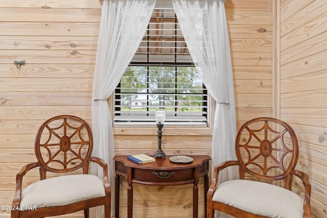 living area featuring wood walls