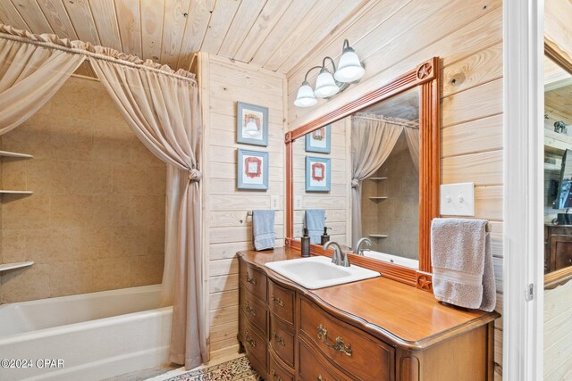 bathroom with vanity, wooden walls, shower / bath combo with shower curtain, and wood ceiling