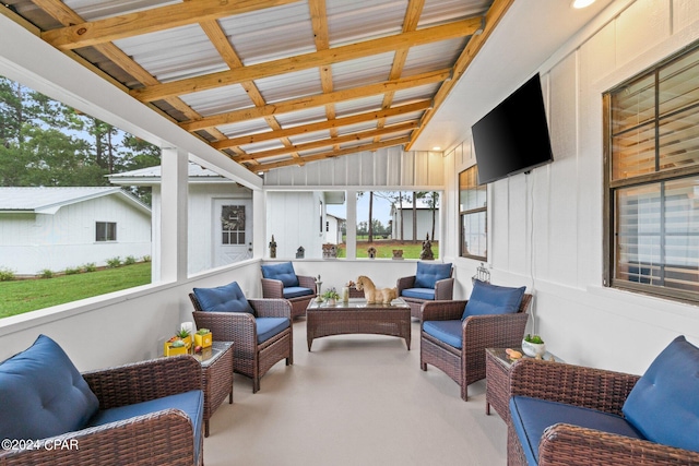 sunroom / solarium featuring vaulted ceiling with beams and plenty of natural light