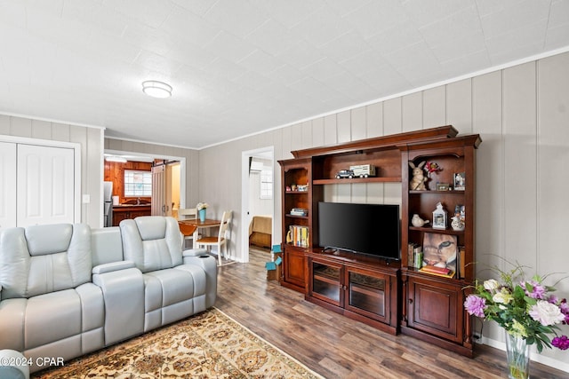 living room featuring wood-type flooring and ornamental molding