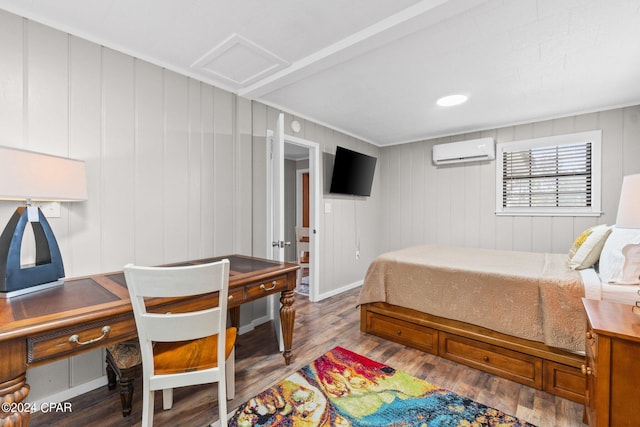 bedroom featuring wooden walls, hardwood / wood-style floors, and a wall mounted air conditioner