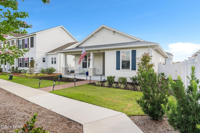 view of front of property featuring covered porch and a front yard