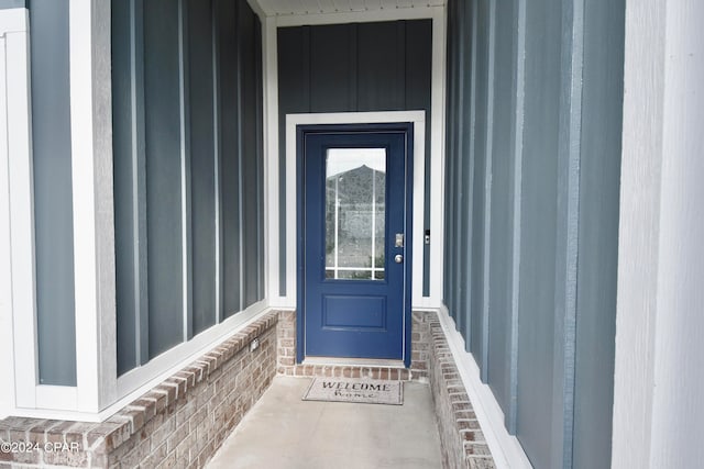 view of exterior entry with a porch