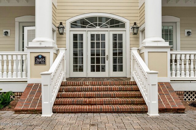 doorway to property featuring french doors and a porch