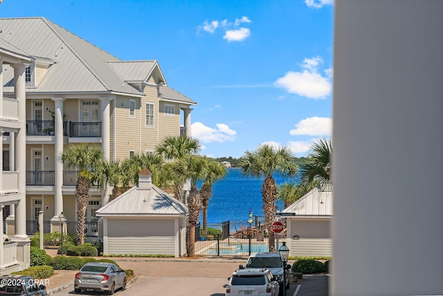 exterior space with a water view and curbs