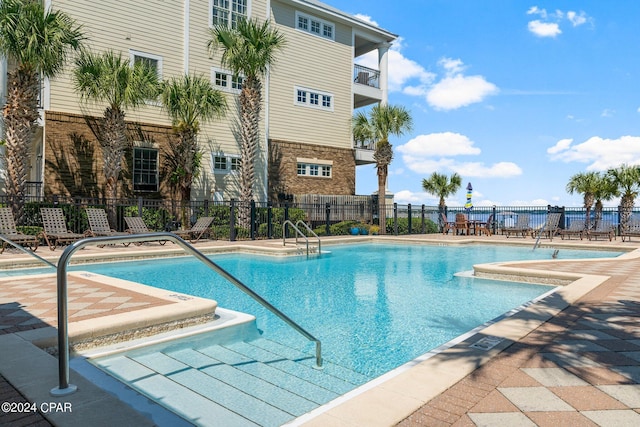 pool featuring a patio area and fence