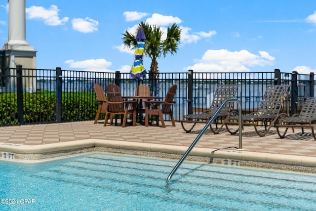 community pool featuring a patio area and fence