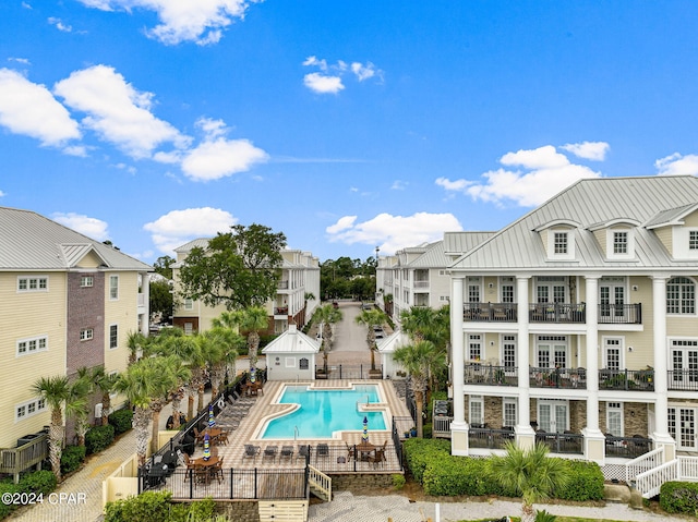 community pool featuring fence and a patio