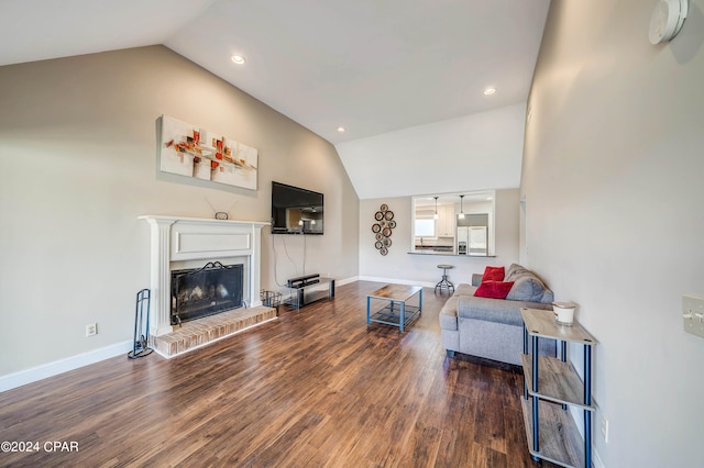 living room featuring a fireplace, lofted ceiling, and hardwood / wood-style flooring