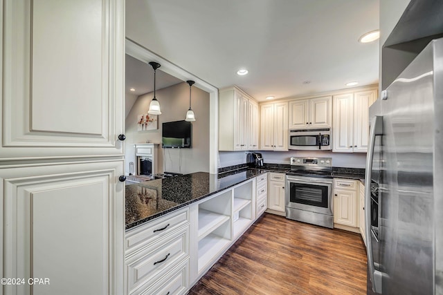 kitchen with pendant lighting, white cabinets, dark wood-type flooring, appliances with stainless steel finishes, and dark stone countertops