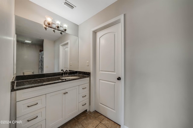 bathroom featuring vanity, toilet, and tile patterned floors