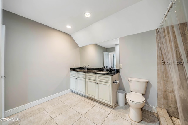 bathroom featuring tile patterned flooring, vaulted ceiling, a shower with shower curtain, vanity, and toilet