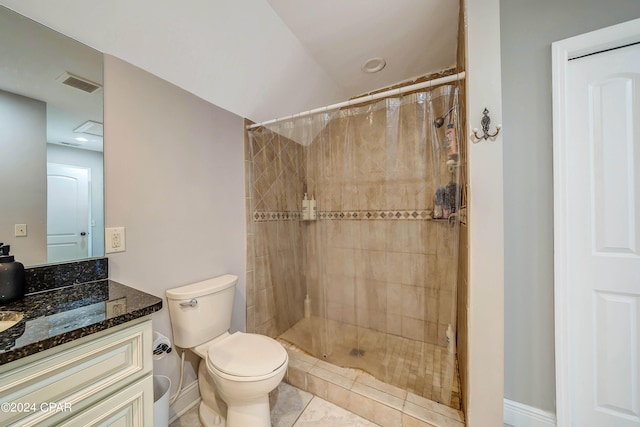 bathroom with tile patterned floors, walk in shower, vanity, and toilet