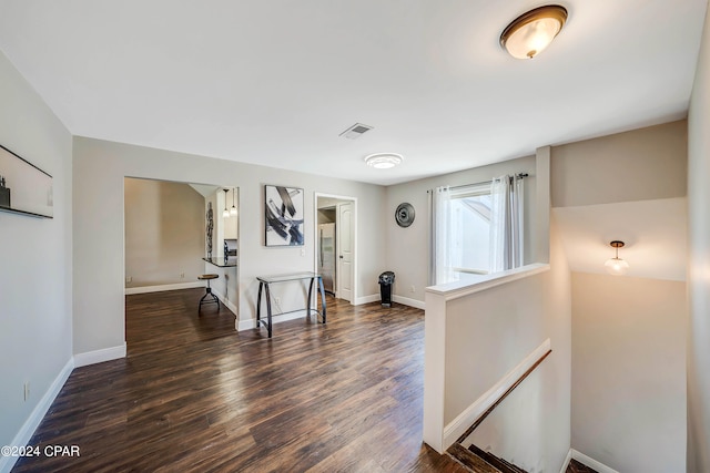 corridor with dark hardwood / wood-style flooring