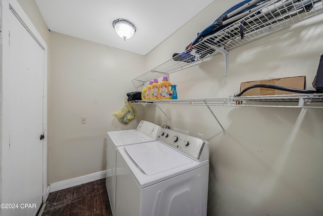 laundry area with dark hardwood / wood-style floors and washing machine and clothes dryer