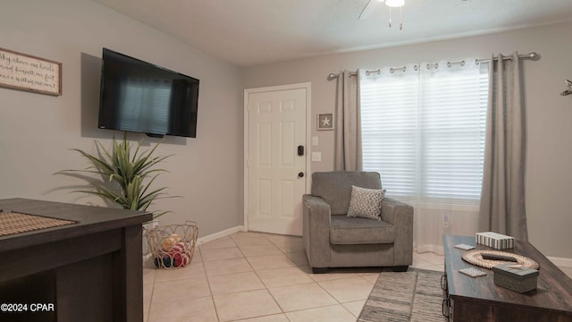 tiled living room with ceiling fan