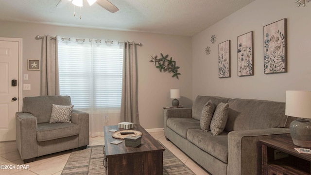 living room featuring ceiling fan, a textured ceiling, and light tile patterned floors