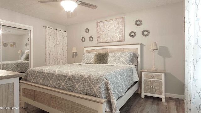 bedroom featuring ceiling fan, a closet, and dark hardwood / wood-style flooring